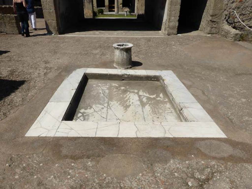 VI.13 Herculaneum, June 2014. Looking south across impluvium in atrium.
On the right, the west ala can just be seen – a kitchen, set up in place of the original ala. Photo courtesy of Michael Binns.